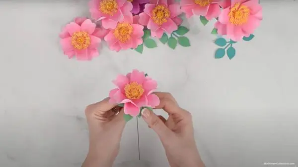 gluing finished wild rose flower to leaf base