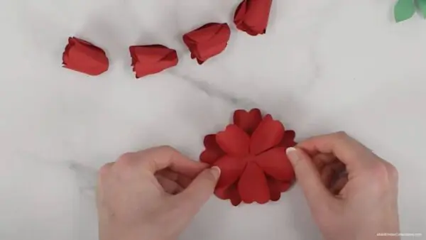 gluing together alternately layered classic rose petals