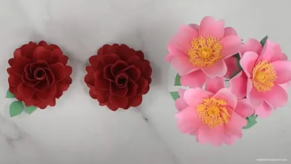 finished display of 2 red classic roses and 3 pink wild roses