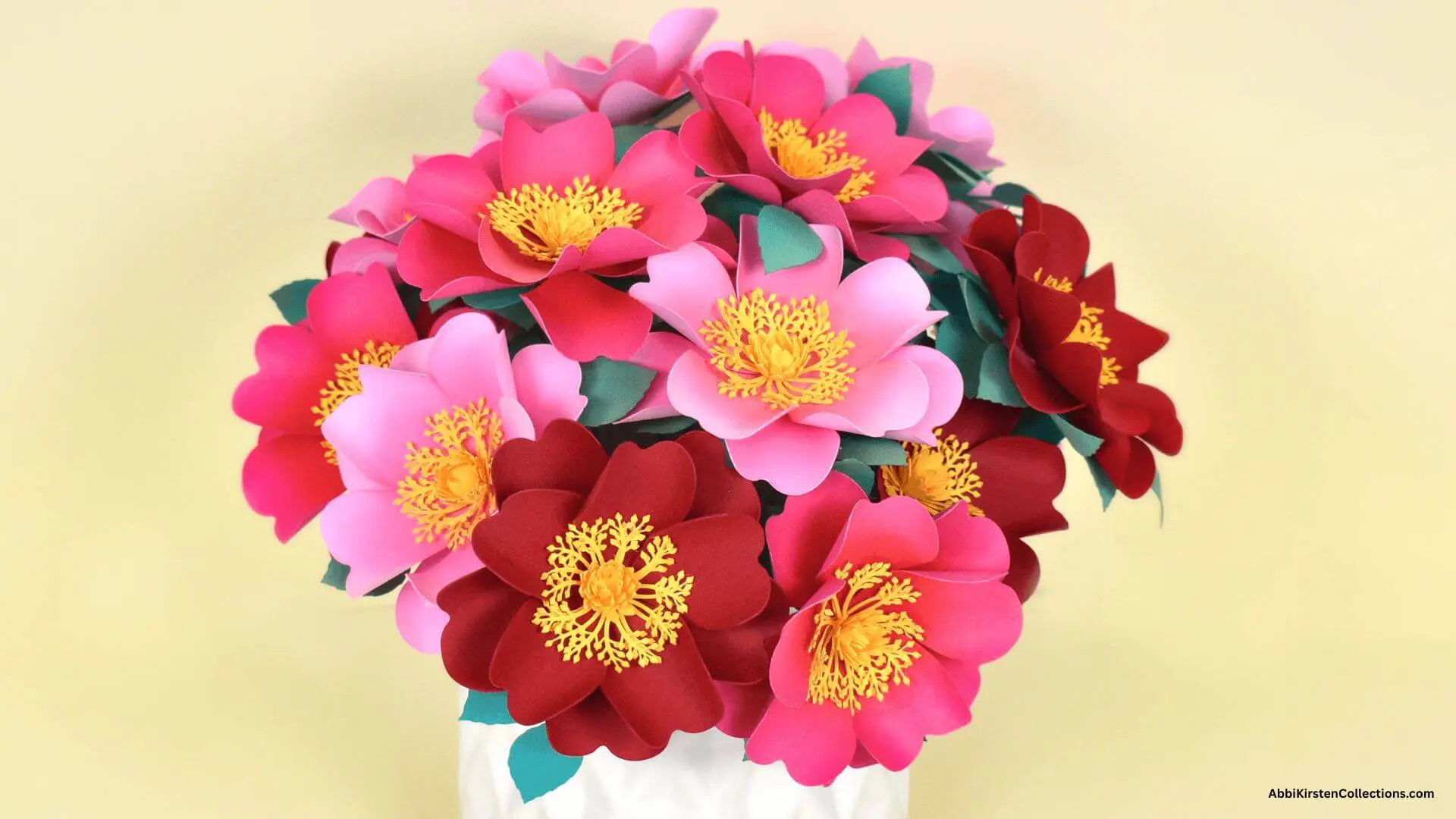 bouquet of pink and red wild roses in a white vase