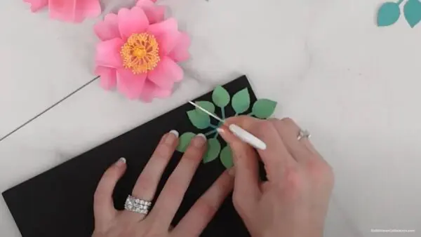 punching hole through center of leaf base with scissors