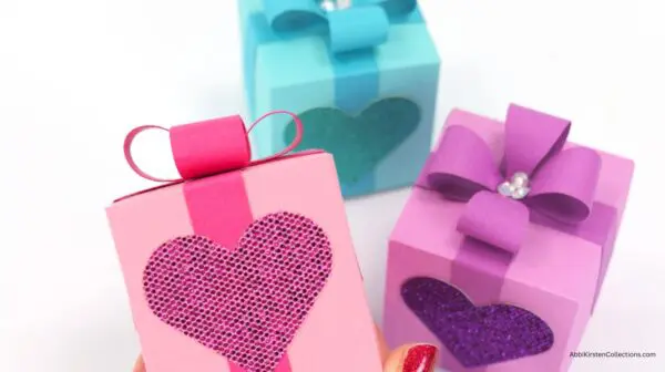 Display of three finished heart gift boxes with ribbon and bows