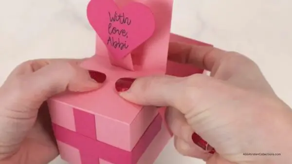 holding glued box to affix glue