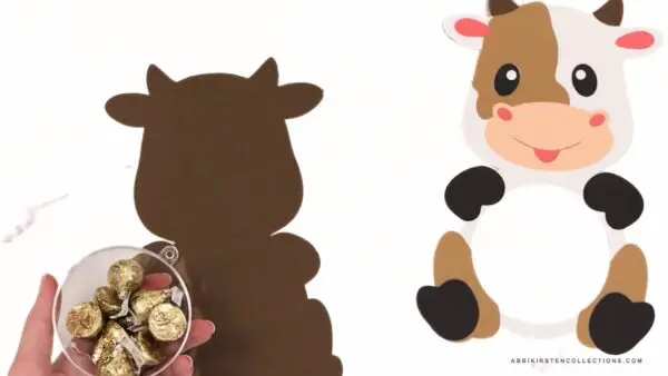 Finished front of cow cutout with details, candy in half ornament, and bottom layer of papercraft