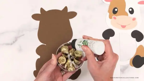 Adding glue to edge of half ornament plastic ball