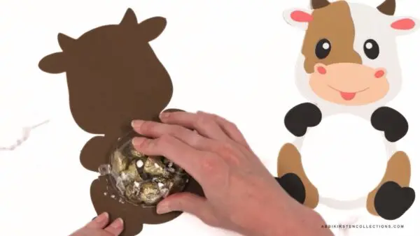 Adding ornament ball half with candy to back cutout