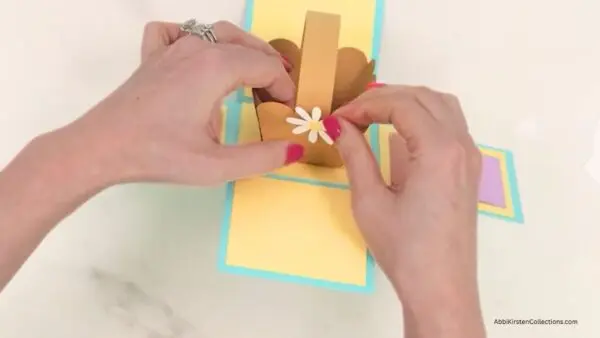 Adding mini daisies to basket handle