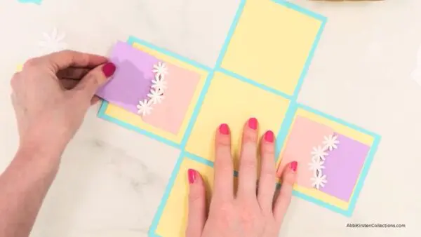 Hand inserting little purple notes into pockets