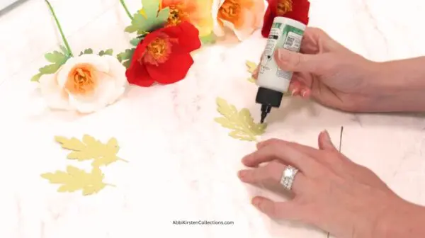 adding glue to paper leaves