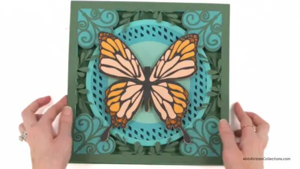 hands holding the 3D layered butterfly design