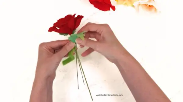 adding leaves to the wire and poppy