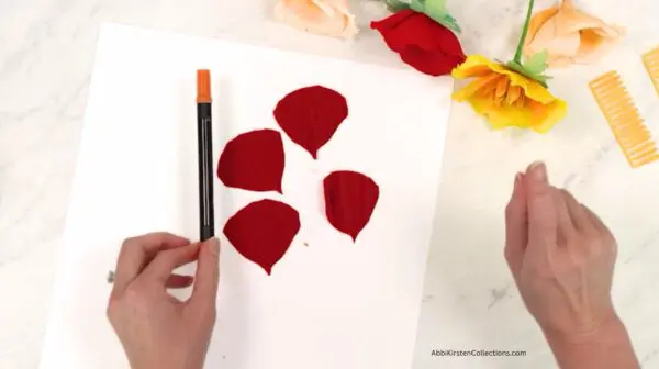 adding orange paint to poppy petals