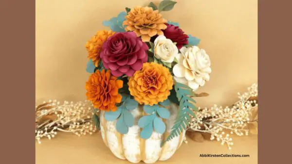 fall colors of marigolds bouquet in faux pumpkin