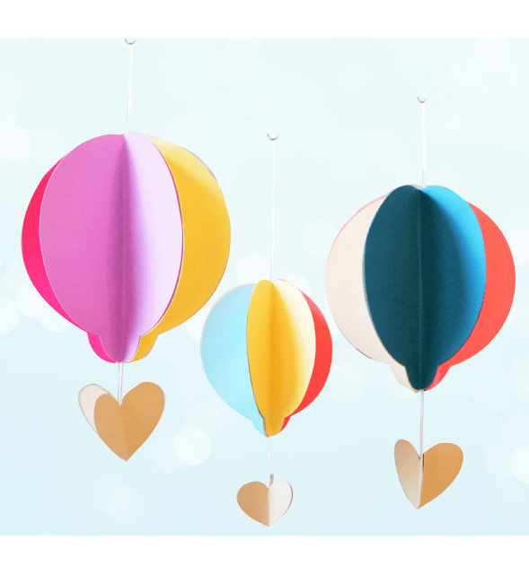 Colorful paper hot air balloons hang from strings