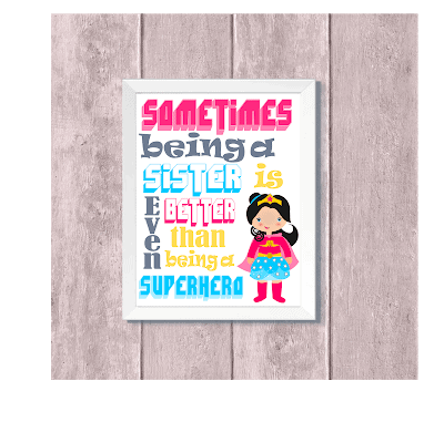 A kid's decoration picture in a white frame has a Wonder Woman-type hero in the lower right hand corner. Above, the text reads. "Sometimes being a sister is even better than being a superhero." 