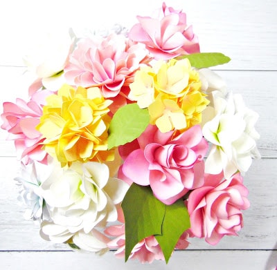 A bird's eye view of the stemmed paper flower DIY wedding centerpiece showing pale and pink paper flowers arranged in a full, gorgeous display. 