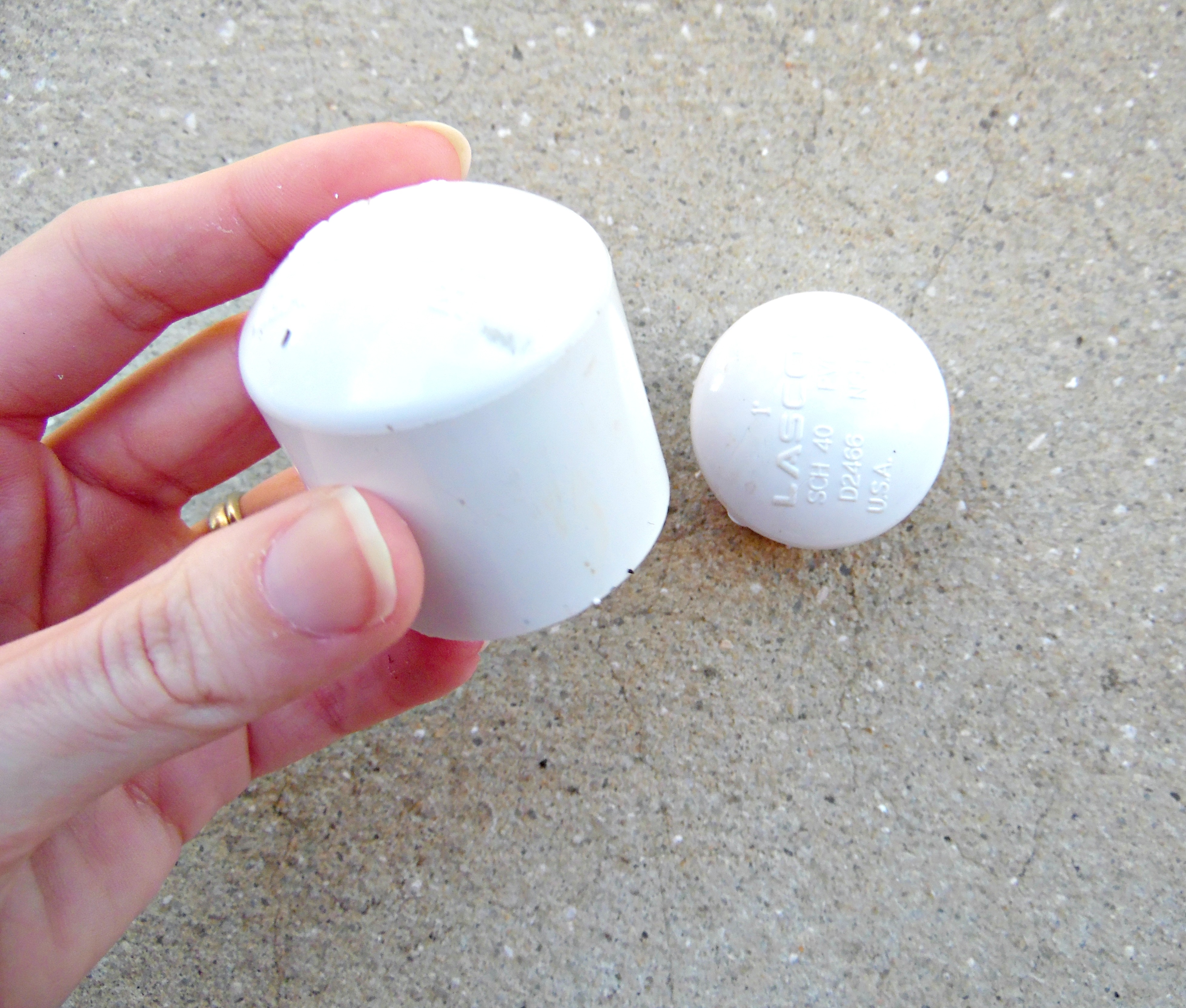 These white plastic end caps are placed over the PVC leg openings for a finished and purposeful look to your giant paper flower stem display stand. 