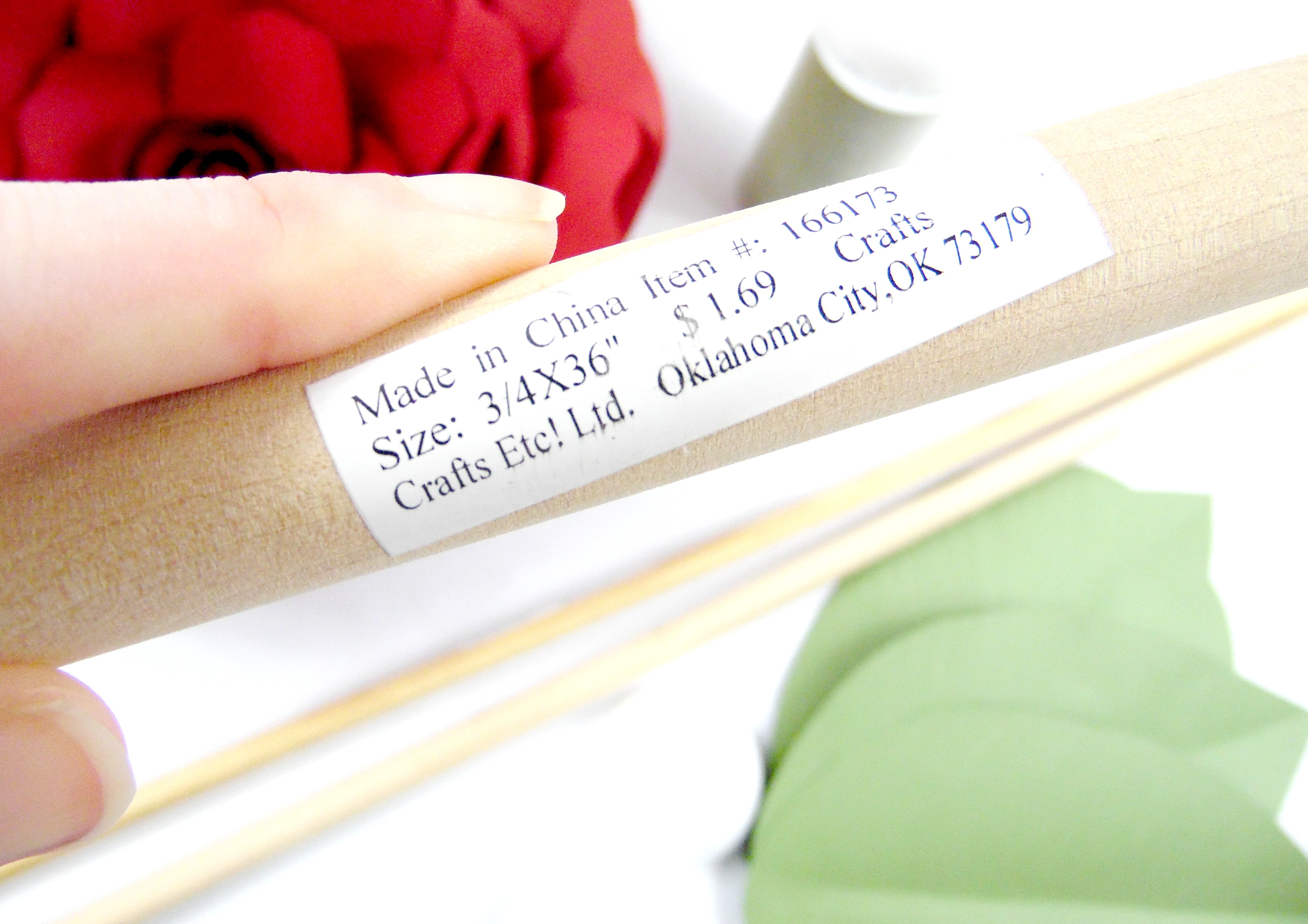 A close-up of a craft dowel sized ¾” x 36”. This particular dowel costs $1.69 from a craft store and makes crafting a giant paper flower stem cost-effective. 