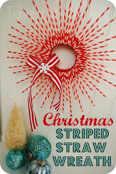 A starburst-style wreath is made from red and white striped paper straws and finished with a red and white strip bow.