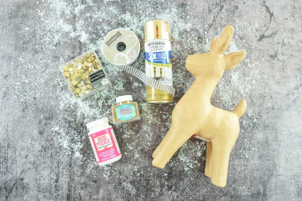 The supplies needed for the gold jewel Christmas deer craft.