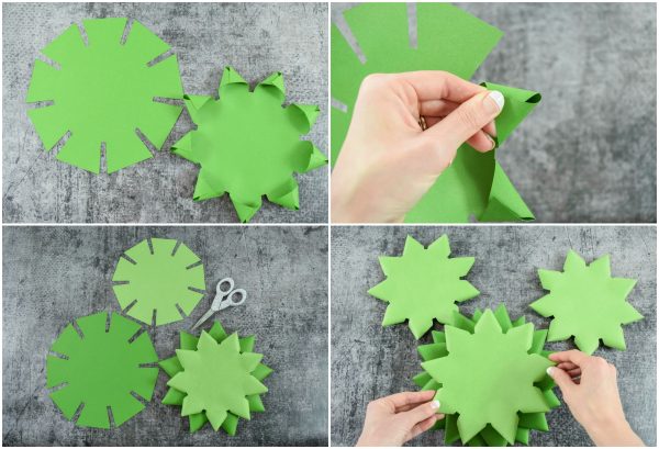 Close-up photos of Abbi's hands demonstrating how to fold each Christmas tree "branch" in a four picture grid. The green circles have tabs that need to be folded together to make points. The background is a grey and black tabletop. All the branch bases were cutout using a Cricut machine. 