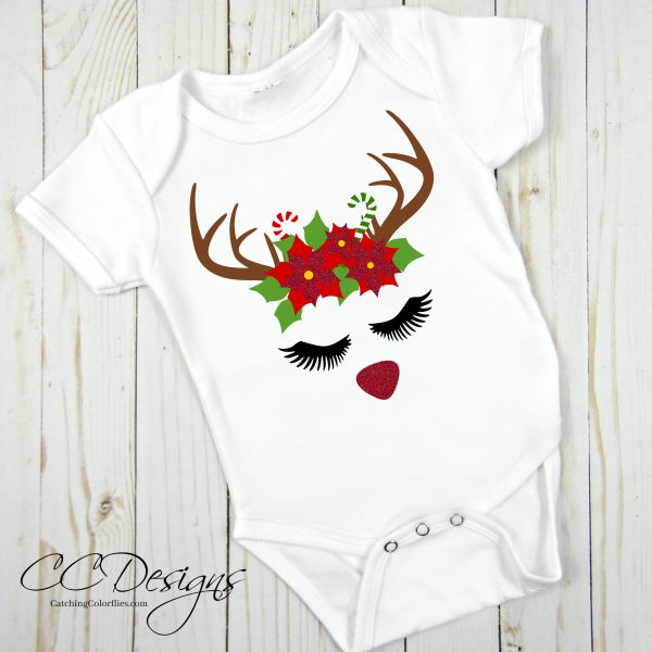 The poinsettias adorn the antlers of a female reindeer and has been ironed on a white onsie. Another example of  how to use the free holiday reindeer free template.  