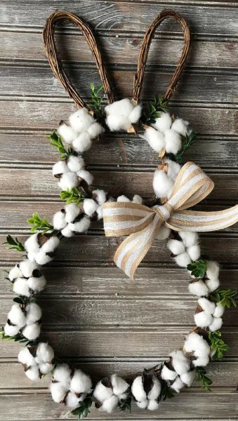 A rustic bunny with cotton balls and a ribbon. 