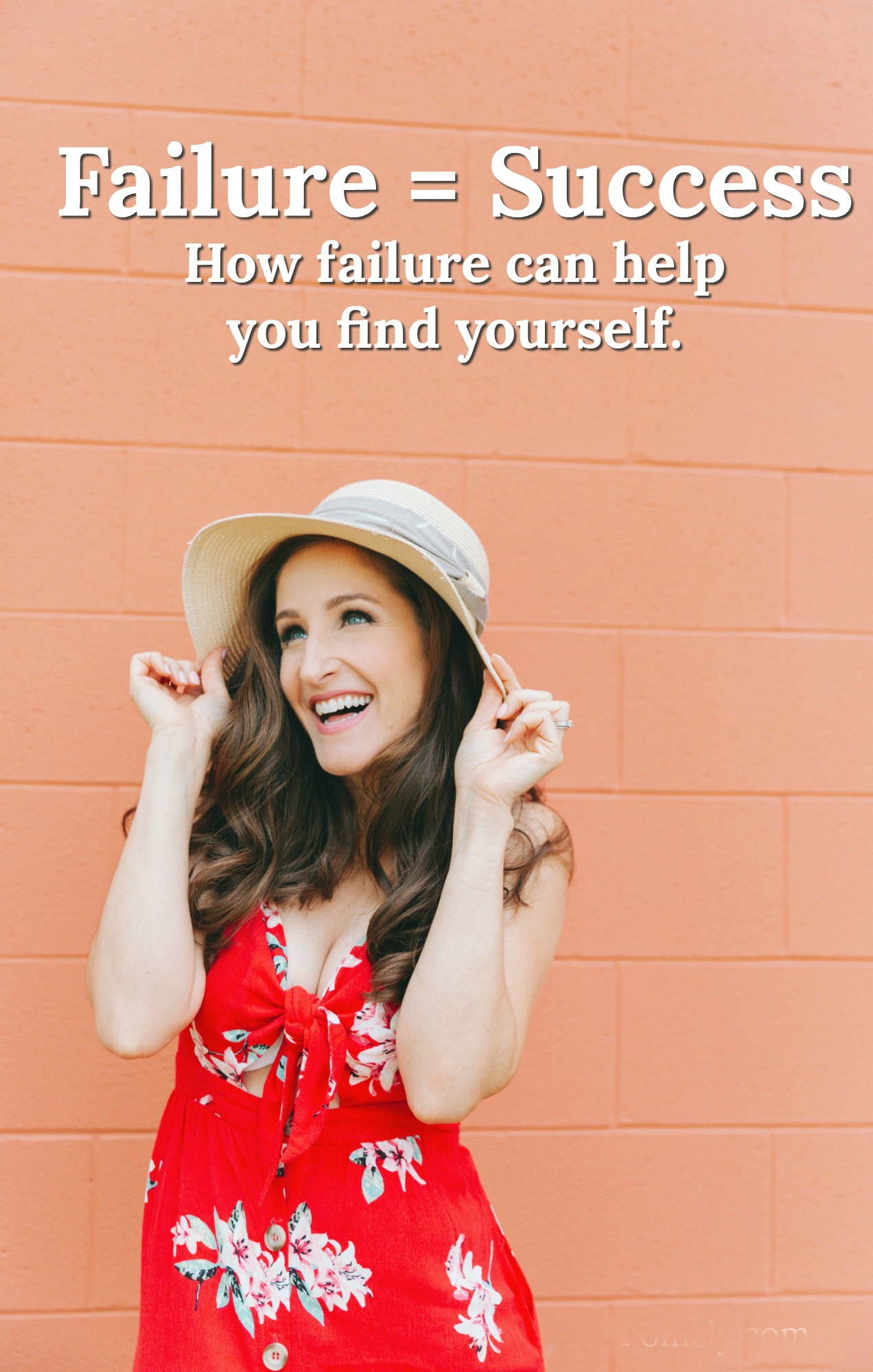 A woman in a red floral dress happily poses in front of an orange brick wall. Text across the top of the image says "Failure = Success" and a smaller line of text underneath that says, "how failure can help you find yourself".