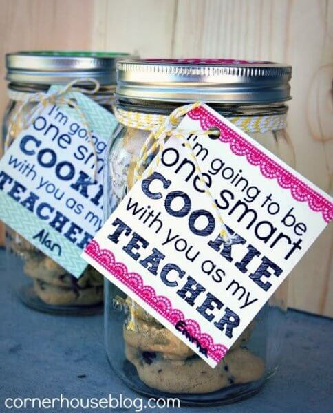 Two mason jars filled with homemade cookies and a sweet back to school gift tag, perfect for gifting to teachers at the start of the school year.