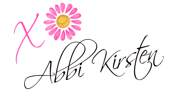 Abbi Kirsten signature logo with a pink and white flower.