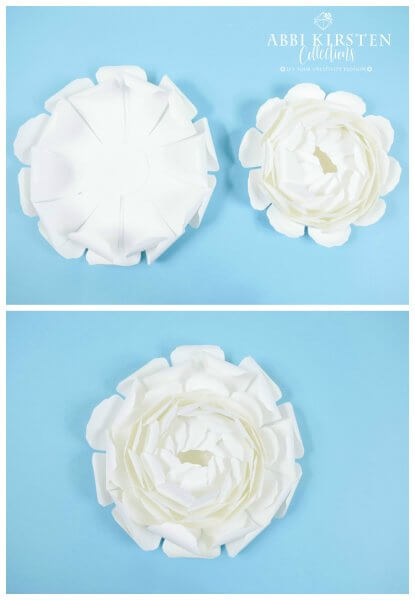 Two layers of peony petals sit next to the center cupped portion of the paper peony. Below, a fully layered white paper peony flower. 