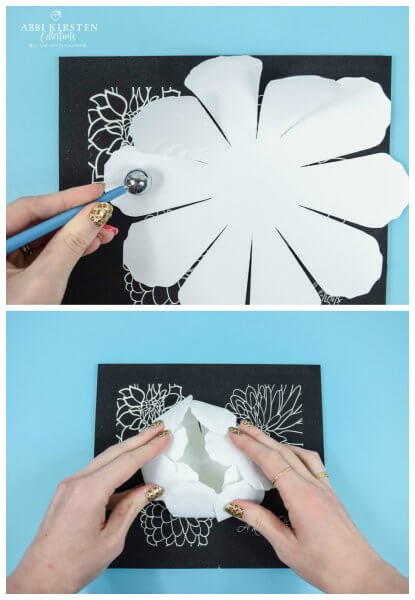 Two stacked images show how Abbi Kirsten cups and shapes the white paper peony petals by using her Paper Blooms Shaping Mat and tools. The mat is black and on a blue paper covered table top.