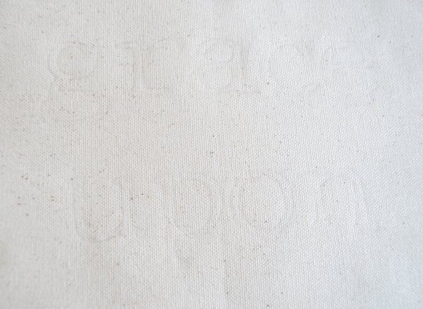 A faint outline that reads "grace upon" is barely visible on cream fabric. 