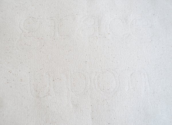 A faint outline that reads "grace upon" is barely visible on cream fabric. 