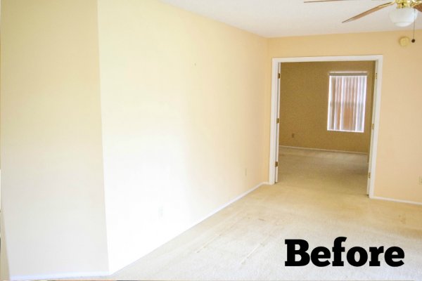A ceiling fan and a large doorway are the focus of this pre-renovated family and living room in Abbi Kirsten's house. "Before" is typed in the corner. 