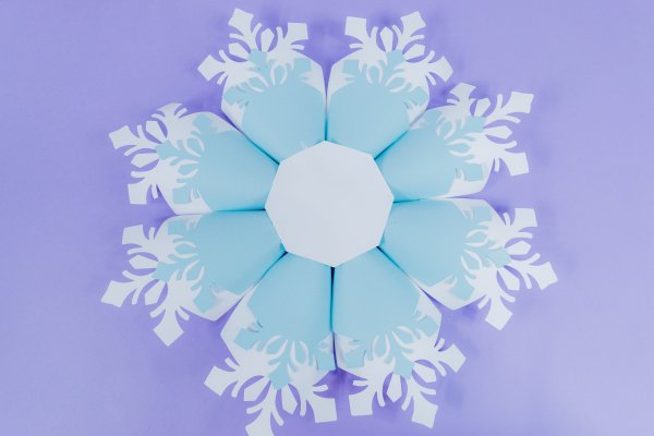 A full look at the in-progress paper snowflake. Eight snowflake petals are attached to an 8-sided base.