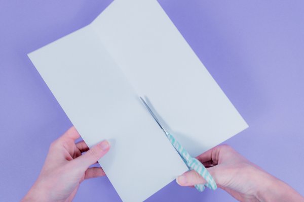 A single piece of light blue paper, folded lengthwise and cut down the center fold with scissors.