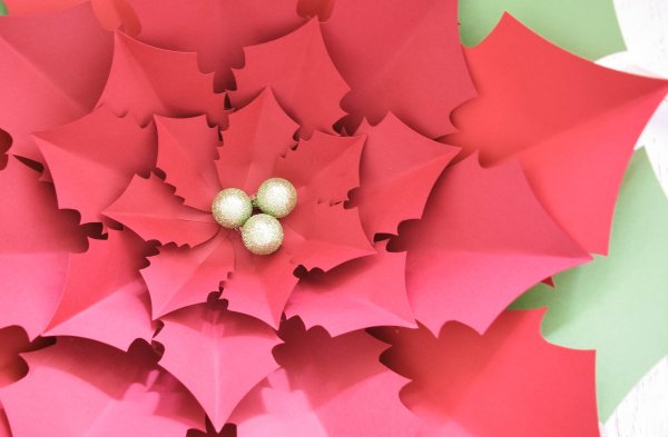A completed Giant Noel Poinsettia flower completed with three holly berries in the center - foam balls spray painted gold with glitter.