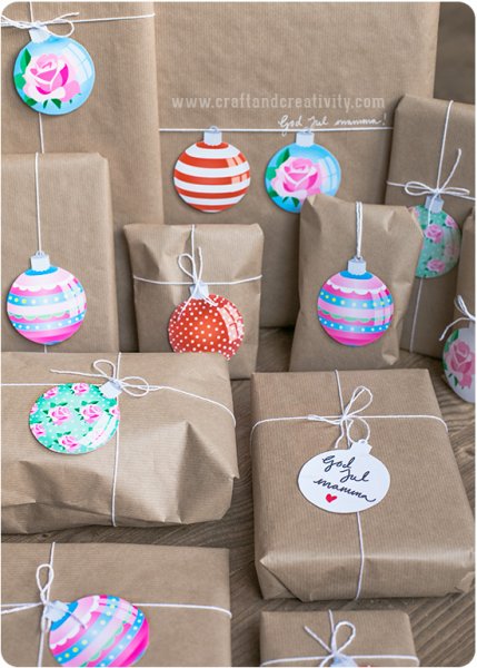 Brown paper packages tied up with string and customized with colorful paper ornament gift tags attached to thin strands of butcher’s string.