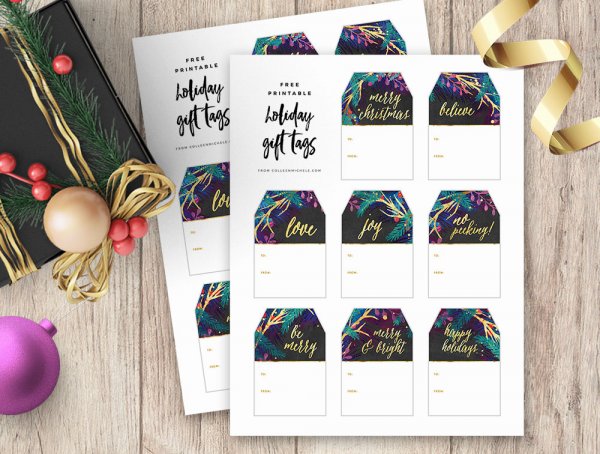 A black-wrapped present sits to the side of two pages of free printable gift tags with a plum and teal design. The combination of dark colors with festive gold is classy and seasonal. 
