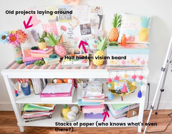 A “before” photo of a craft room shelving unit crammed with random stacks of craft paper and old projects. You can learn to organize your craft room. 