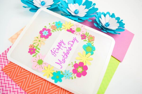 A completed DIY Floral Happy Mother's Day card atop bright colorful paper.