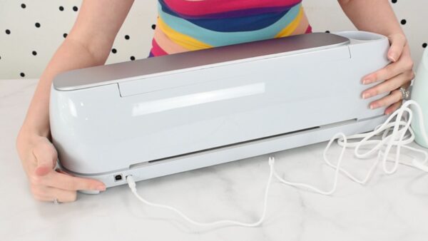 Show how to plug in your Cricut machine power cord. 