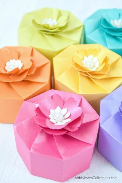You can make these adorable paper gift boxes in all your favorite colors like pink, purple, yellow, orange, and green, using a Cricut craft machine.