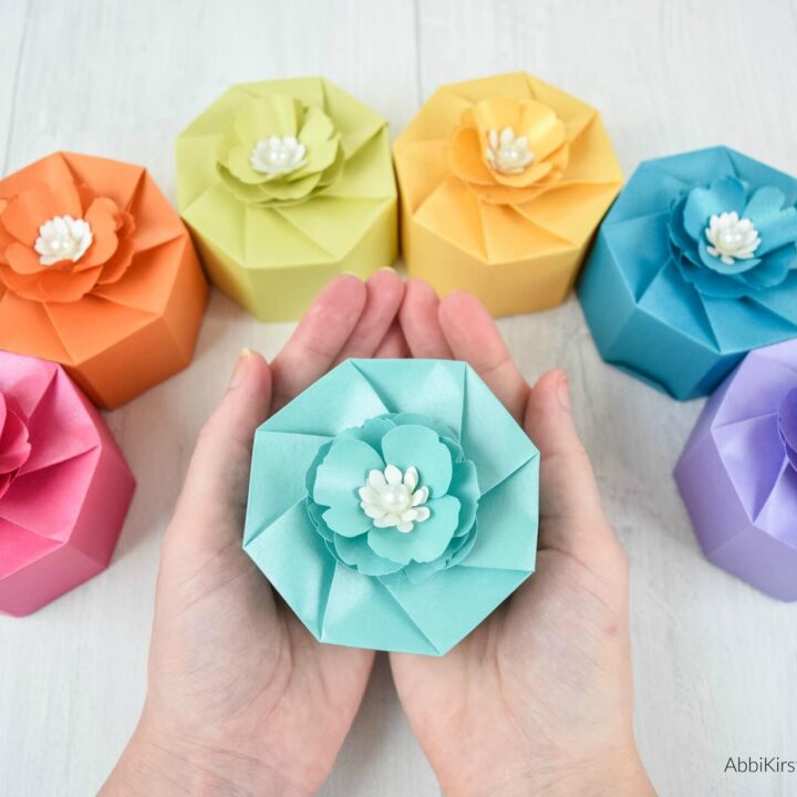 hands holding a light blue paper box