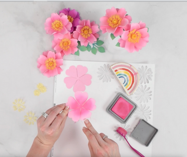 Grouping of pink flowers being applied with distressed ink