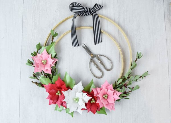 A photo showing how paper flowers can be attached to embroidery hoops to create lovely wreaths. 