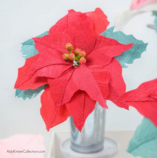 Crepe Paper Poinsettia Flower Tutorial: Create Christmas and Holiday decor with this free poinsettia template and step by step tutorial. 