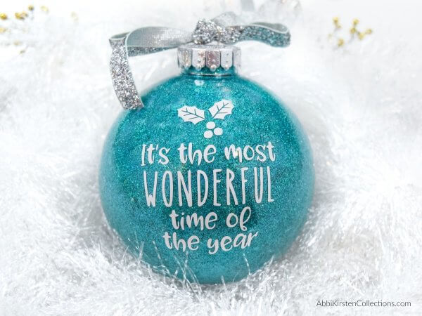 DIY Glitter Ornaments: How to make easy custom Christmas ornaments with vinyl. Free Christmas word SVG cut files and how to put vinyl on a curved surface!