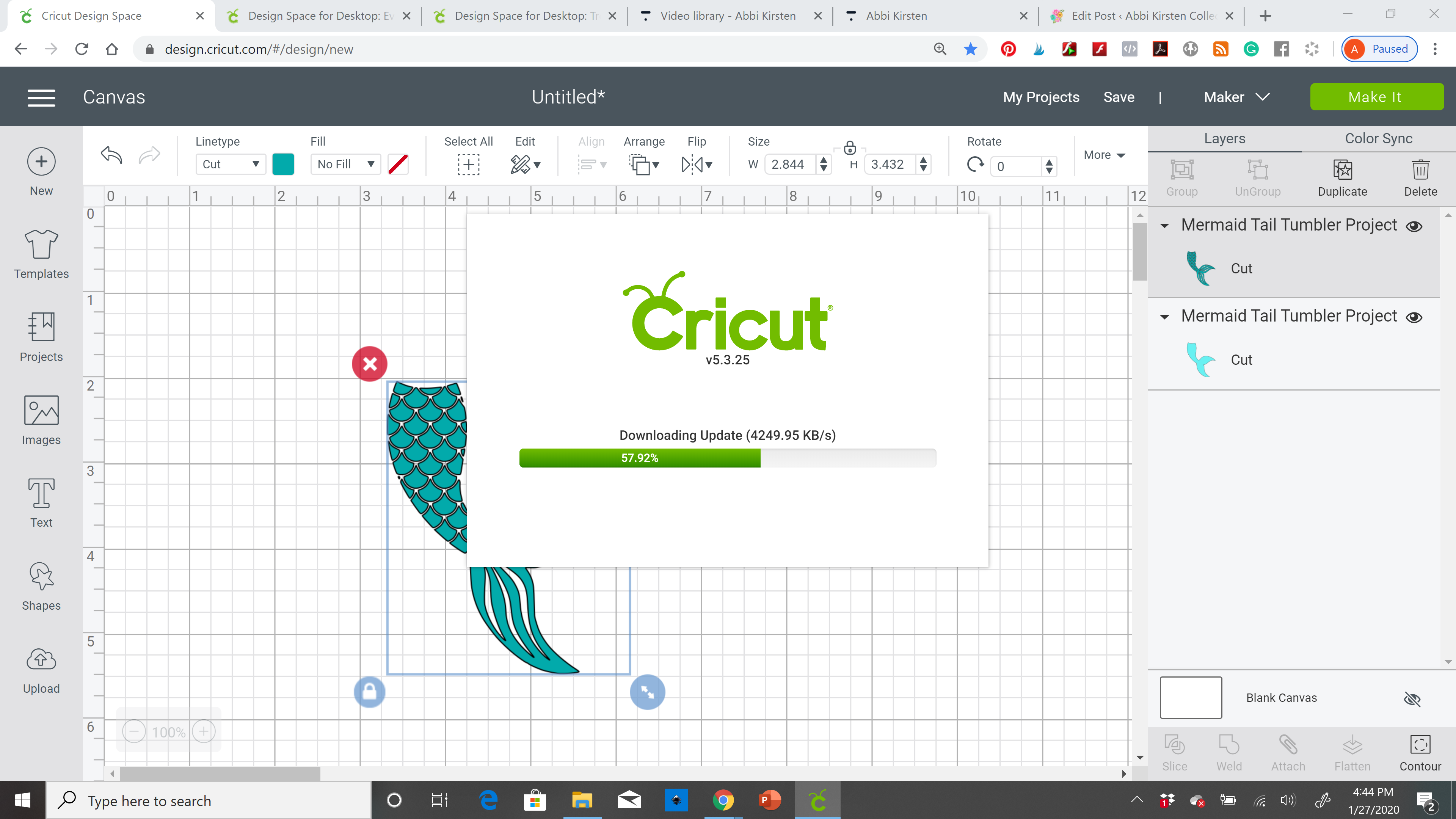 A computer screenshot of Cricut Design Space with the design canvas grid open. A popul on the screen shows a download progress bar at 57%. A mermaid tail graphic is on the Design Space grid in the background.